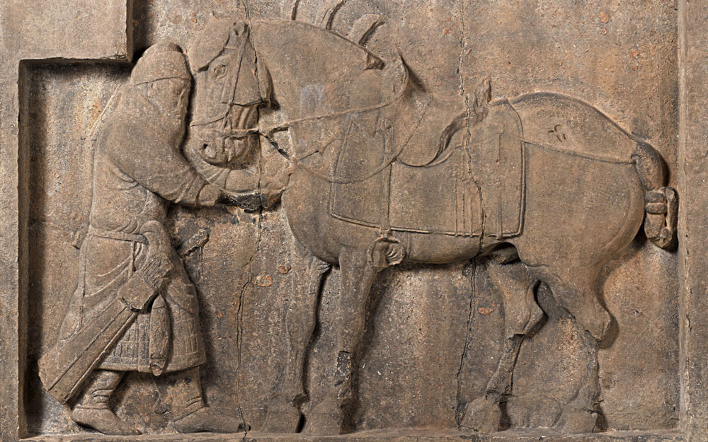 Relief of a general pulling an arrow out of the horse's chest while it stoically bears the pain.