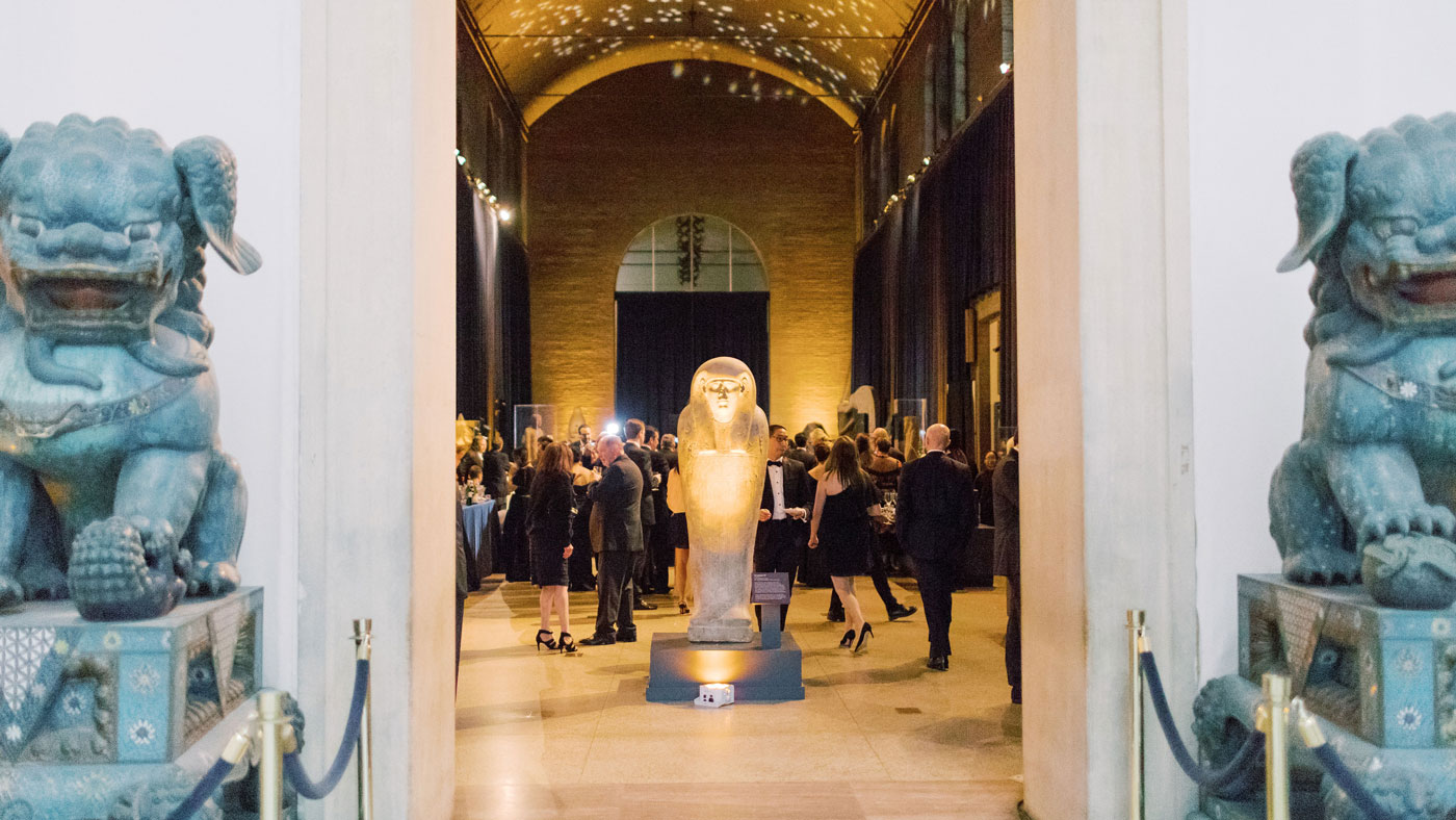 A reception in the Egypt Gallery, as seen through the Asia Gallery.