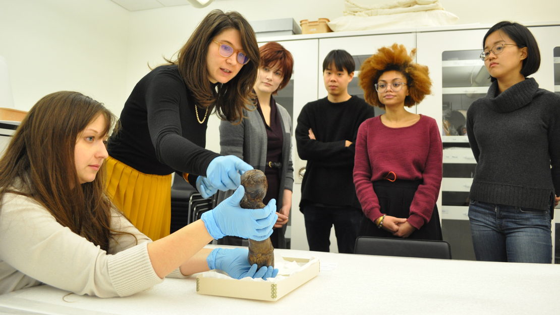 A group of people examining the collections in a lab.