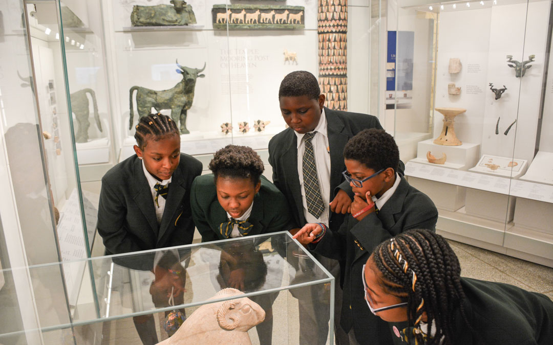 Students admiring an object.