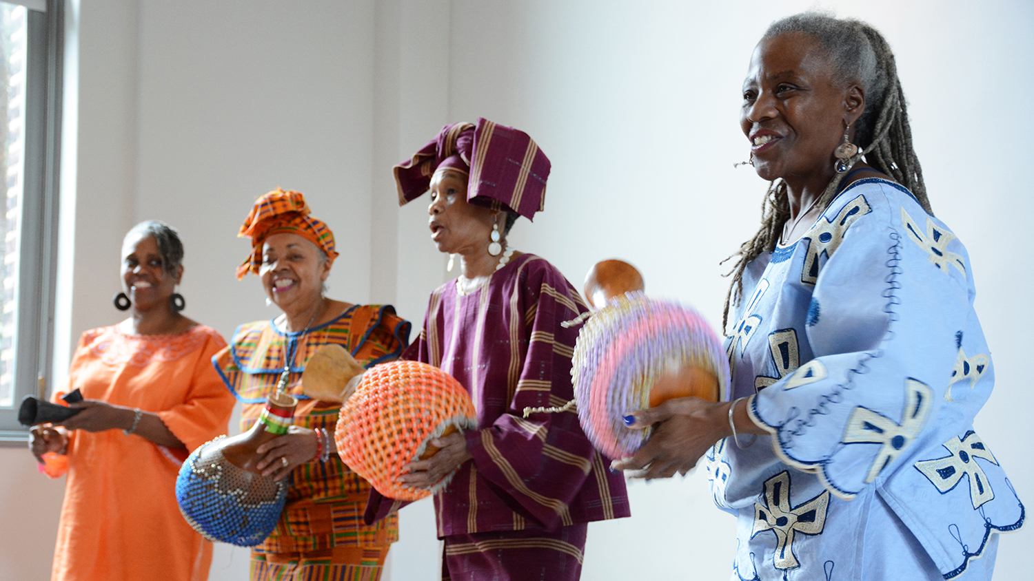 Women in African garb performing.