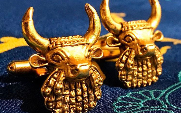A pair of gold earrings in the shape of the bull's head from the bull headed lyre.